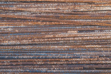 Background texture of old rusty steel bars construction materials in a construction site