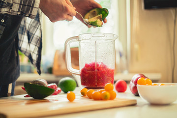 cutting fruits and vegetables to put them in blender to make smoothie mix