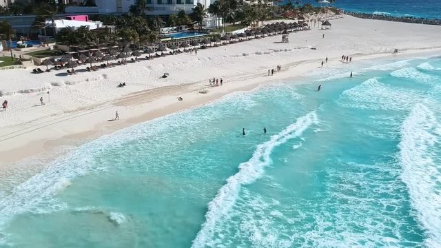Aerial shot of the hotel zone in canc&uacute;n, in a sunny day hitting the blue waters of the caribbean. Getting close to the shore.