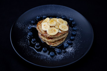 Healthy banana pancake with blueberry heart shape and strawberry