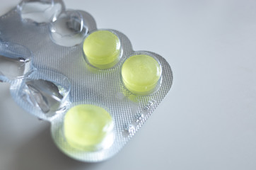 Close up of some medicine tablets/throat lozenges in a blister pack. Copy space for text.