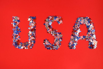 4th of July American Independence Day background . Holiday confetti usa flag colors decorations on red  background. top view, 