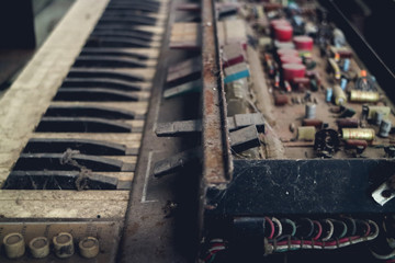 The piano vintage with electronic dilapidated in storage room