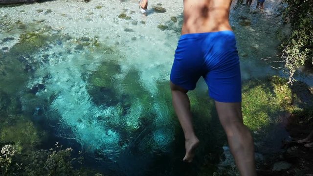 young man Diving Swimming In turquoise Water.The Blue Eye,Albania,august 2019