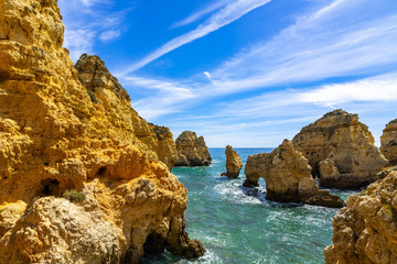 Fototapeta na wymiar The golden cliffs and turquoise ocean waters at Ponta da Piedade, one of the most iconic landscape of Algarve, Portugal