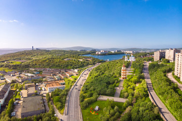 Fototapeta na wymiar Murmansk, Russia - July 1, 2019: Aerial view memorial Lighthouse, church and anchor monuments, Panorama northern city. Cargo Port gulf of sea