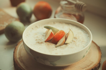 Breakfast useful porridge and sandwiches is on the table