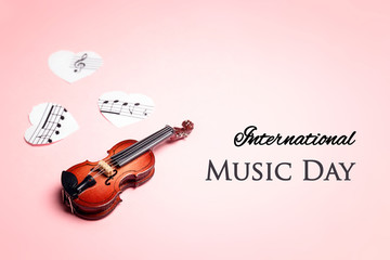 International Music Day background miniature violin and music hearts. © WindyNight