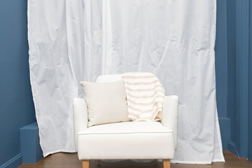 Fototapeta na wymiar front view of single wooden leather chair with blue interior wall and white curtain.