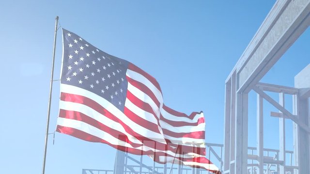 Ghosted Right Facing American Flag Waving Slow Motion With Home Construction Wood Framing Background
