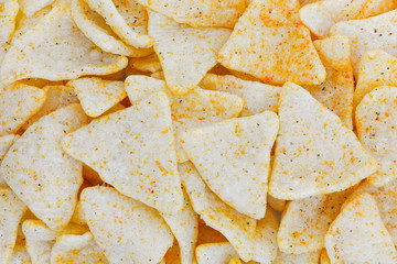 top view of spiced and salted tapioca or cassava chips in triangle shape texture for background