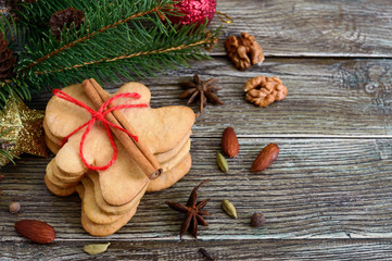 Christmas homemade gingerbread cookies and spices on the wooden background. Christmas mood. Happy New Year and Christmas. Holiday Postcard