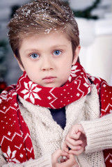 boy at Christmas by the fireplace and Christmas tree