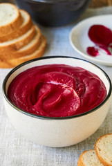 Thick beetroot cream soup in a gray bowl  