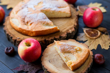 Naklejka na ściany i meble Homemade apple pie on a wooden dark table, top view.