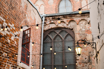 Cozy outdoor summer terrace. Hanging decorative lights