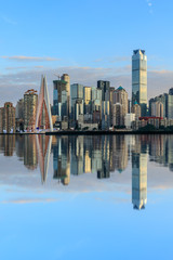 Obraz premium Chongqing skyline and modern urban skyscrapers with water reflection at sunset,China.