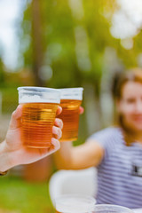 Friends enjoying drinking beer in the backyard.