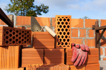 Mason bricklaying background with trowel and clay brick blocks