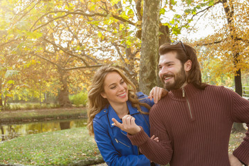 Couple in the park enjoying nice autumn time.