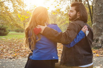 Couple in the park enjoying nice autumn time.