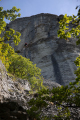 The vertical walls of the stone of Bismantova with two climbers. Vertical shot.