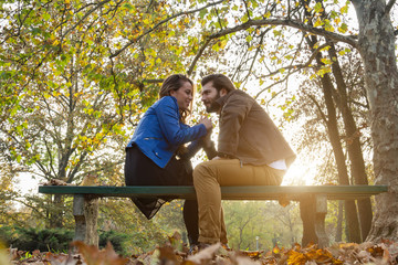 Couple in the park enjoying nice autumn time.