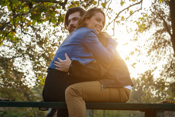 Couple in the park enjoying nice autumn time.