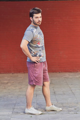 Young man posing in front of a camera.