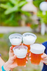 Friends enjoying drinking beer in the backyard.
