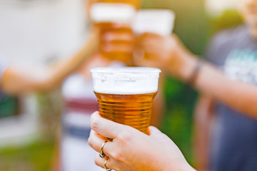 Friends enjoying drinking beer in the backyard.