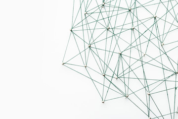 A large grid of pins connected with string. Communication, technology, network concept