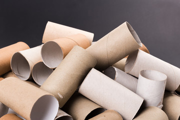 Empty Toilet Rolls Stack Up On a Black Background
