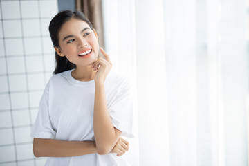 Fototapeta premium Close up young woman smiling face with clean skin in room 