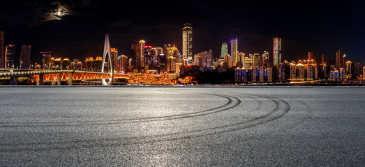 Race track ground and city financial district with buildings in Chongqing at night,China.