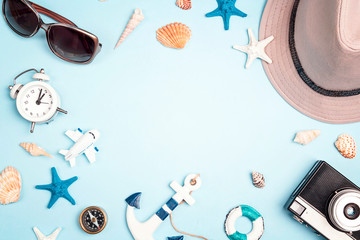Frame of vacation accessories on a blue background. Flat lay travel concept .
