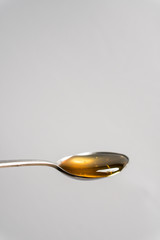 spoonful of Manuka honey on white background