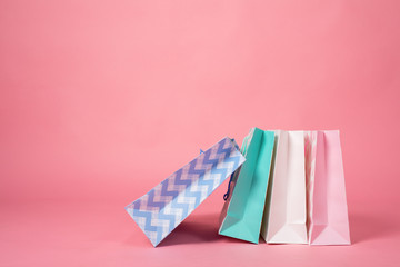 colorful shopping bags at pink background