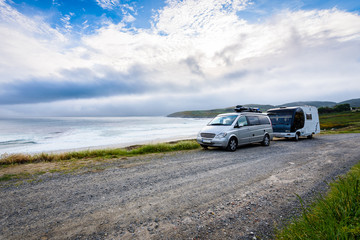 Fototapeta na wymiar Motorhome RV and campervan are parked on a beach.
