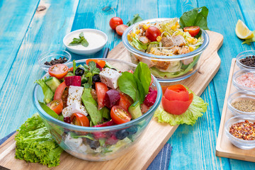 Mixed Vegetable Salads on Blue Wood Background - Mixed Gourmet Food , Mixed Healthy Food - Chicken Salad / Cheese Salad - Green leaves / Salad with Lettuce Leafs on Top and Cherry Tomatoes