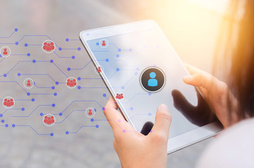 Woman hand hold using smart phone at outdoor park street with people icon and line dot background. Copy space of technology business and travel holiday concept.