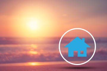 Copy space of blur tropical beach and bokeh sun light wave with home icon abstract background. Summer vacation adventure and holiday travel freedom concept.