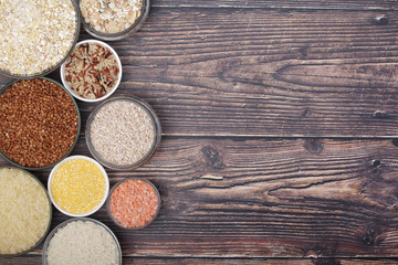 A set of bowls filled with different seeds: buckwheat, rise, corn and oatmeal	