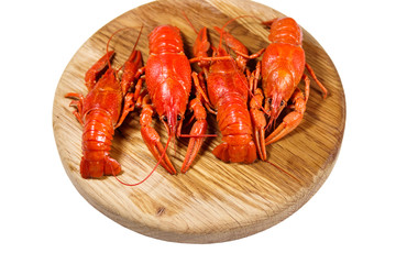 Boiled crayfish on wooden cutting board isolated on white background