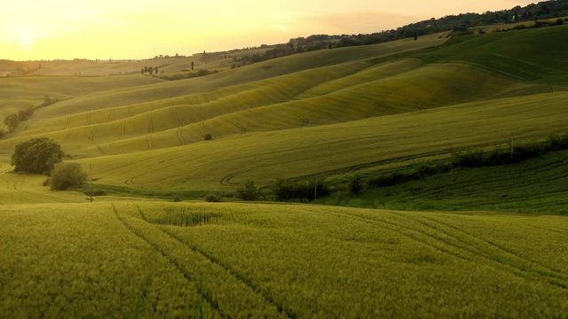 Flying over the amazing rolling hills of Tuscany Italy at sunset