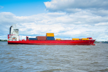 huge red barge with large containers on board. shipping cargo transportation by sea