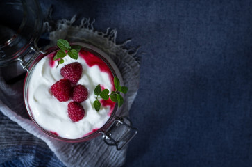 Healthy dietary delicious breakfast in jar on blue background. Close up. Healthy eating and self care concept.