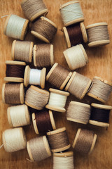 Set of thread on wooden background
