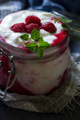 Healthy dietary delicious breakfast in jar on blue background. Close up. Healthy eating and self care concept.