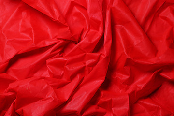 red fabric texture of background. Piece red fabric suitable for a textured background. Soft pleats on fabric